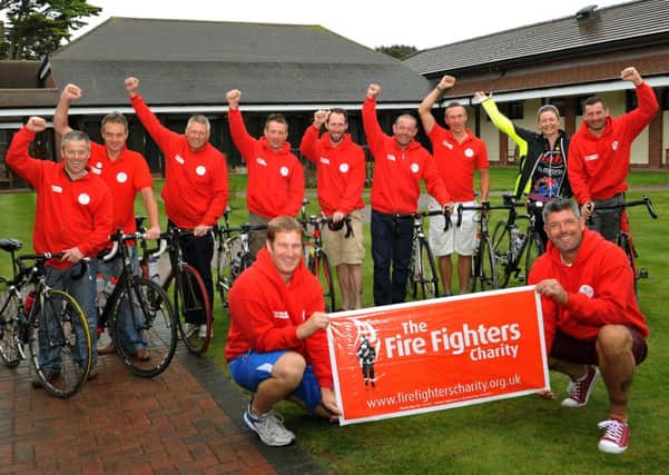 Firefighters triumphant at the finishing line of the 600-mile ride which ended in Littlehampton L40712H14