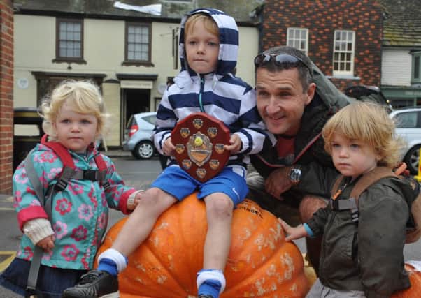 The winners - Noah, Jacob and Mabel, seen with Dad and that winning pumpkin SUS-140810-120314001