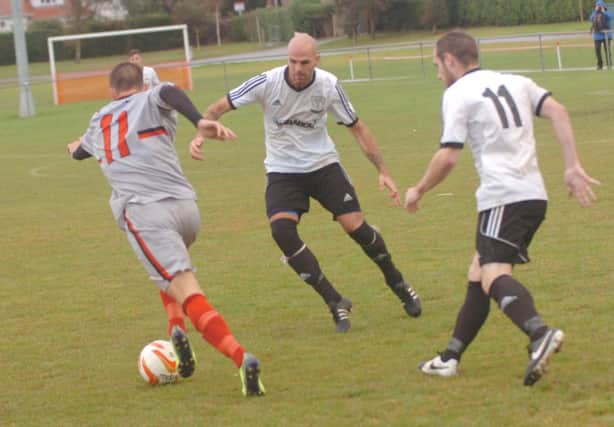 Bexhill United manager Marc Munday (centre) in action against Rochester United in the FA Vase on Saturday. Picture by Simon Newstead (SUS-140710-093914002)