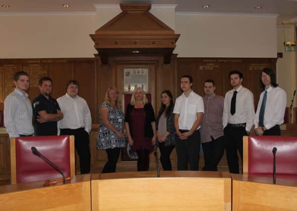 Alex Cryer ( far left) the 200th Journey to Work programme participant photographed in the  Horsham District Council Chamber alongside other colleagues currently benefitting from the scheme. SUS-140910-164154001