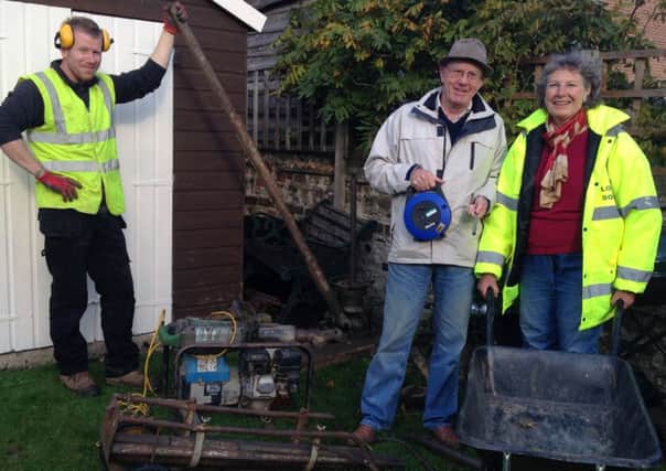 Littlehampton Flood Action Group members Angela Tester and Danny Surridge with Gerry Burgess, left, of Soils Ltd SUS-141010-153640001