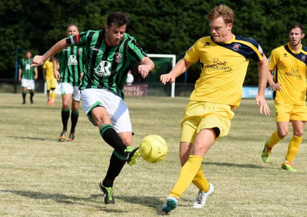 Football. Sussex League. Burgess Hill V Eastbourne Brough friendly. Action from the match.  Burgess Hill's Scott Kirkwood  tackles  Eastbourne's Adams Watt .   Picture: Liz Pearce 260714. SUS-140726-200909008