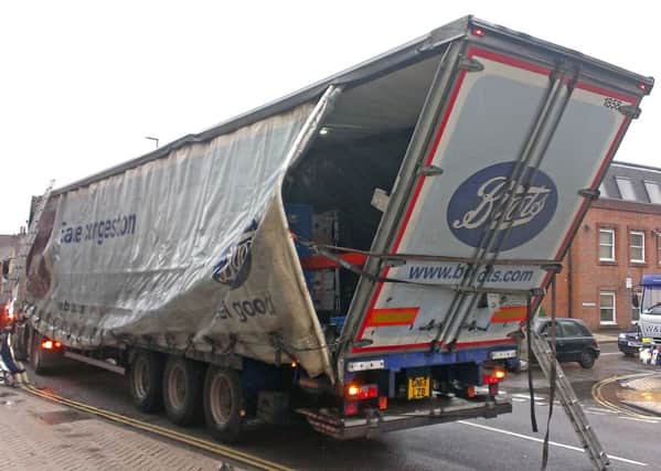 JPCT 131014 S14439998x Lorry damage holds up traffic in Horsham, Queen Street -photo by Steve Cobb SUS-141013-084303001