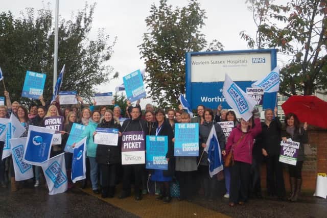 NHS workers on the picket line outside Worthing Hospital this morning SUS-141013-112932001