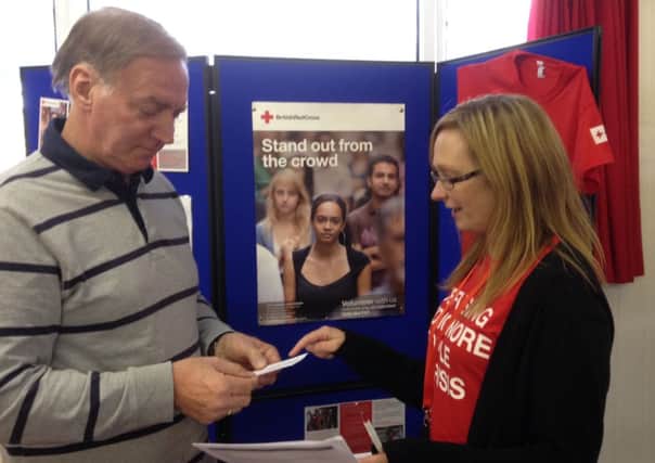 Judith Fitter Health & Social Care Coordintor with a new volunteer John Pickett SUS-141013-125522001