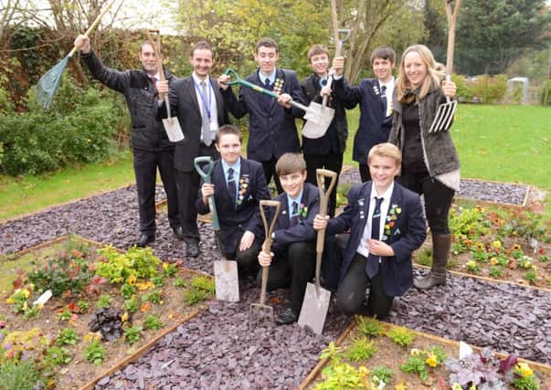 Students at The Angmering School working on the memorial garden. Photo by Derek Martin           D14411440a