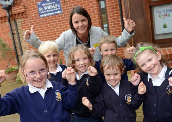 Head teacher Sharon Reynolds and pupils celebrate a promising Ofsted monitoring report D14411426a