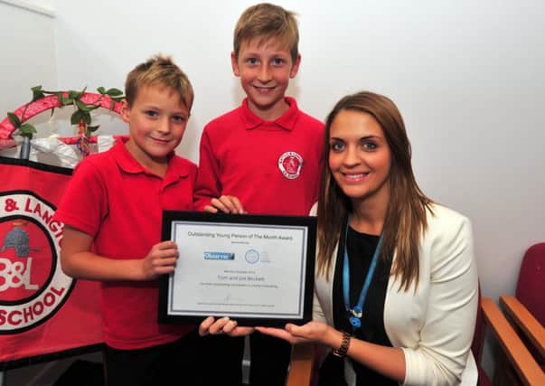 9/10/14- Lauren Fry from Sussex Coast College presents the Outstanding Young Person of the Month to Joe and Tom Beckett, Battle. SUS-140910-170400001