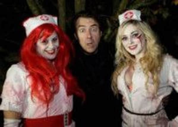Jonathan Ross at Tulleys Shocktober Fest Scream Park with the zombie nurses, part of the street entertainment team. Photo: Stephen Candy