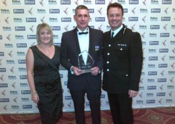 Mark Emery with his wife Lynne and Assistant Chief Constable Robin Smith.
