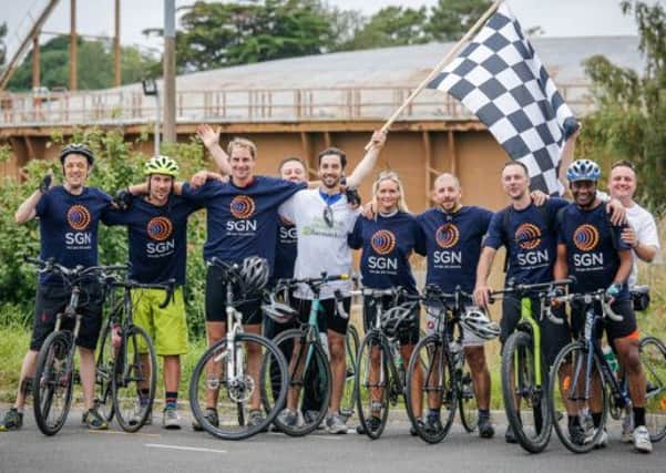 Becky (5th from right) and her fellow riders reach the finish line at SGNs Poole depot SUS-141020-092511001