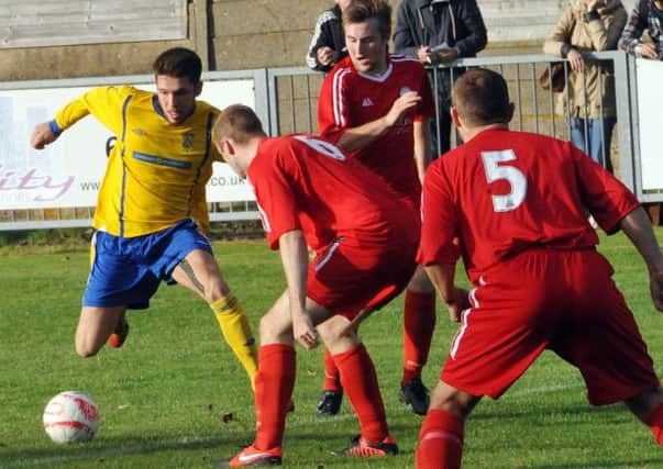 Lancing's Lewis Finney takes on the Shoreham defence