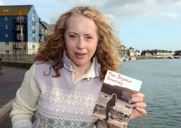 Allis Moss with her book, in Littlehampton harbour. Photo: Derek Martin D14391932a