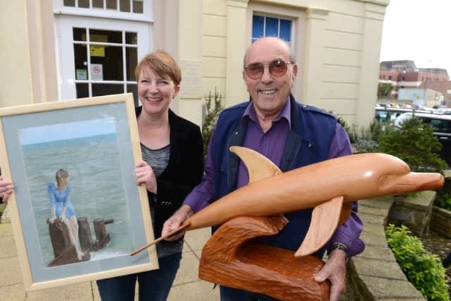 Karen Boxall, who won the visitors vote for her painting, Breakwater, with third-placed Brian Castle, with his dolphin wood sculpture