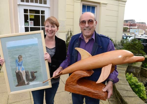Karen Boxall, who won the visitors vote for her painting, Breakwater, with third-placed Brian Castle, with his dolphin wood sculpture