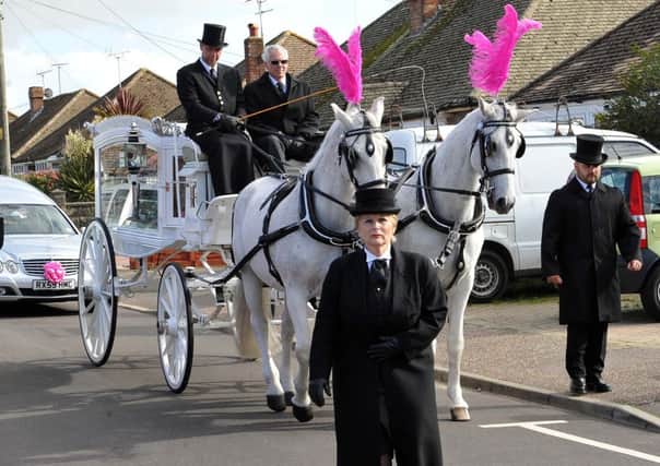A horse-drawn carriage led the funeral procession