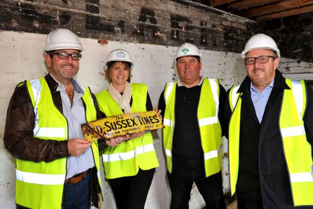 Old Mid Sussex Times memorabilia found at the former offices in Boltro Road, Haywards Heath. Pictured with the advertising sign are developers Adam and Karen Cutts of Arkk Endeavours, with Jamie Nicoll (building contractor) and Stephen Crathern from PSP Homes. Pic Steve Robards