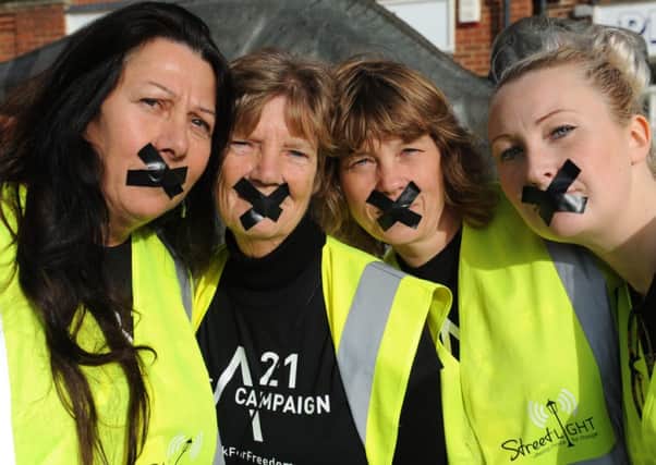 JPCT 181014 S144440723x Southwater anti-trafficking walk. Taped mouths symbolises 'not having a voice' -photo by Steve Cobb SUS-141018-135046001