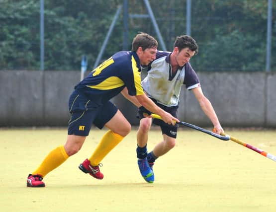 Alex Coombs in the thick of the action for South Saxons Hockey Club against Eastbourne II on Saturday. Picture by Steve Hunnisett (SUS-141018-173638002)
