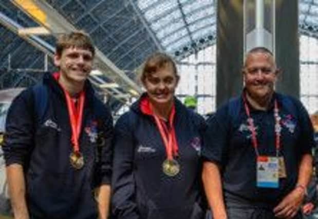Thomas Farley (left) and Holly Tadman proudly wear their European gold medals alongside coach Paul Everest