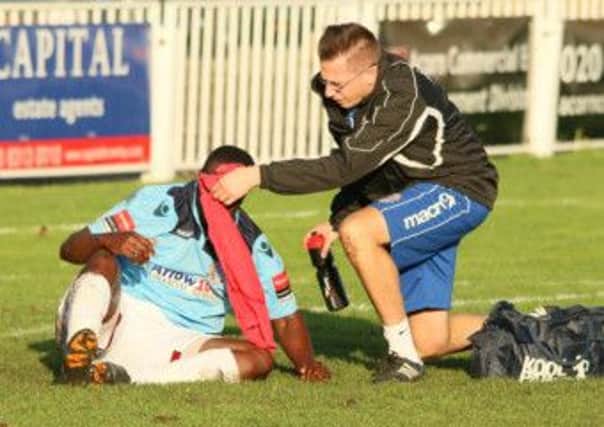 Hastings United physio Dane Martin tends to Ade Olorunda during the FA Trophy defeat away to Cray Wanderers on Sunday. Picture courtesy Joe Knight