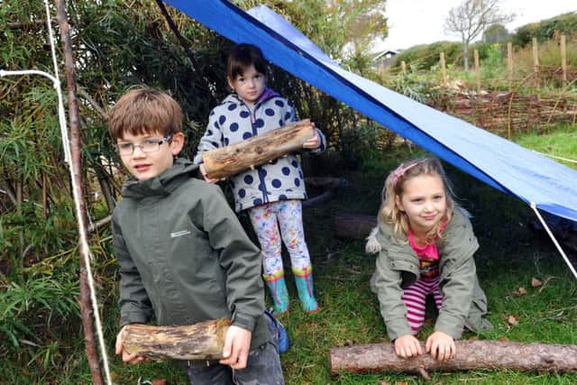 Pupils at East Preston Infant School helping to build one of their outdoor tents for their forest schoolL43504H14