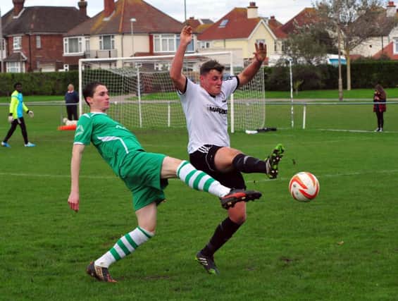 George Aston gets a foot in during Bexhill United's 2-0 win at home to Rustington. Picture by Steve Hunnisett (SUS-141027-121154002)