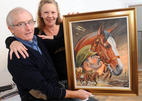 JPCT 041114 S14460370x Horsham. Art Ache Gallery. Artist Pete Oldreive with gallery owner Sally Bushnell and his painting 'A Warhorse' -photo by Steve Cobb SUS-140411-084908001