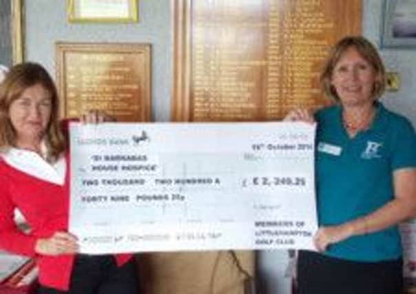 Nikki Greenwood, left, of the Littlehampton Golf Club handing over a cheque to St Barnabas House hospice's with Mary Bye SUS-141028-112710001