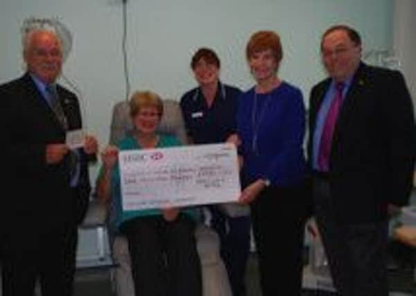 Battle Rotary club President Peter Mills was accompanied by Past Presidents Marian Rigby and Michael Bett when he presented a cheque for £1,000 to League Chairman Cllr Stuart Earl. Senior Staff Nurse Lesley Guthrie called in her unit colleagues for the photo-call, healthcare assistant Rose Buckler posing in one of the chairs,