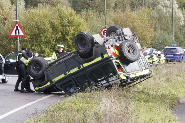Police inspect the scene after this Land Rover flipped onto its roof in Angmering         PHOTO: Eddie Mitchell SUS-141028-172608001