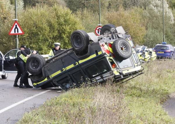 Police inspect the scene after this Land Rover flipped onto its roof in Angmering         PHOTO: Eddie Mitchell SUS-141028-172608001