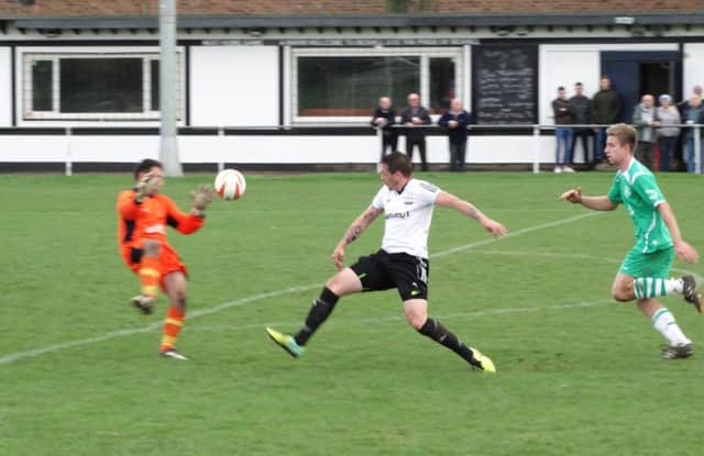 Bexhill v Rustington football action - Bexhill United striker Jamie Morgan (centre) goes for goal during the 2-0 win at home to Rustington. Picture courtesy Mark Killy