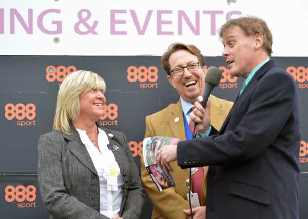 Councillor Andy Cooper, vice-chairman of Arun District Council, centre, with wife Ali  presenting a prize during race four, the chairmans handicap hurdle SUS-141031-162304001