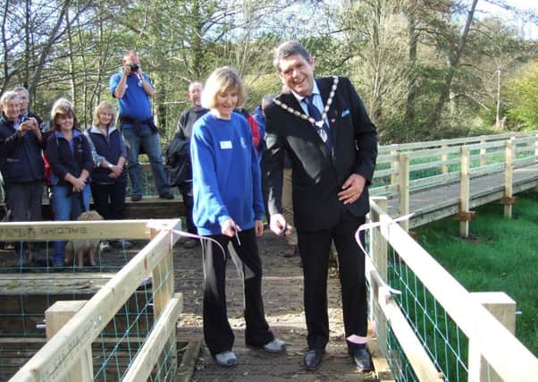 Diane Sumpter chair of Friends of Chesworth Farm and Brian O'Connell chairman of Horsham District Council at official opening of a wetlands project at Chesworth Farm on Saturday November 1 (submitted). SUS-140311-110204001