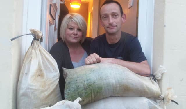 Rosie Morse and Harvey Stephens are fed up with flooding issues in Station Road. They have both bought sandbags to protect their homes SUS-140411-091540001