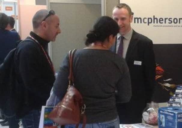 Lee from McPhersons giving advice at a trade fair SUS-140511-081557001