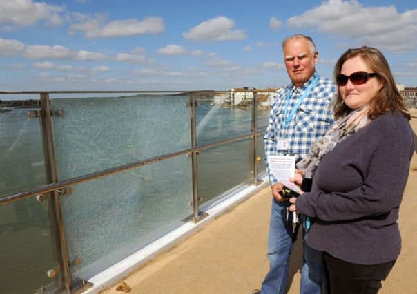 District councillors David Simmons and Emma Evans beside the shattered glass on Adur Ferry Bridge D14161103a