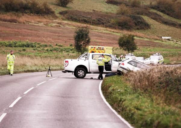Police investigate the scene at the Long Furlong crash in Patching yesterday. PHOTO: Eddie Mitchell SUS-141025-081936001