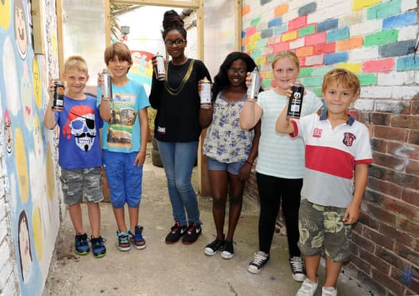 Help guide youngsters like these in fulfilling schemes such as a graffiti art project L35121H13