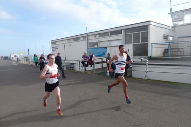 Third-placed Greg Cole (left) and eventual winner Daniel Watt set the early pace in the Poppy Half Marathon. Picture by Simon Newstead (SUS-141011-205355002)