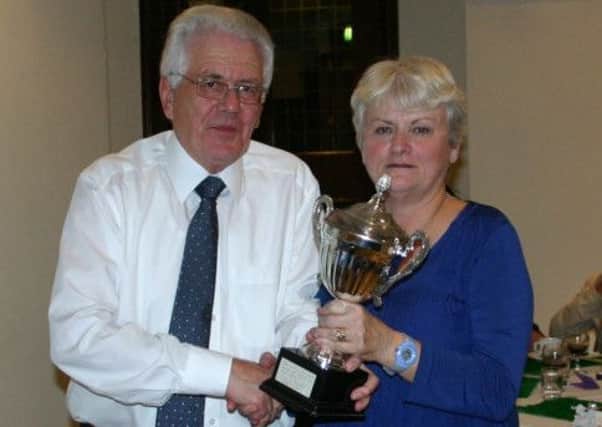 Midhurst's Peter West presents Catherin Dixon with some of her silverware