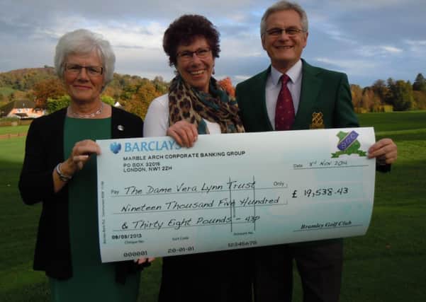 Rosie Wyer, Regional Fundraiser at the Dame Vera Lynn Trust, gratefully accepts the cheque from Jean Hooper and Terry Vermigle SUS-141114-130009001