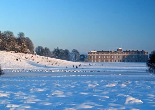 Petworth House in the snow, with families sledging. Picture by Martin Offer SUS-141114-142452001