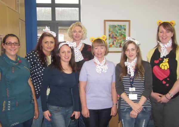 Staff at Worthing Homes don spotty scarves and Pudsey ears
