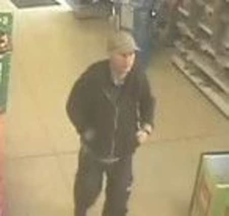 Police are searching for a man they suspect of stealing a poppy tin from a Goring store on Remembrance Sunday SUS-141118-123335001