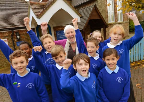 Smiles all round as head teacher Janet Llewelyn celebrates with pupils