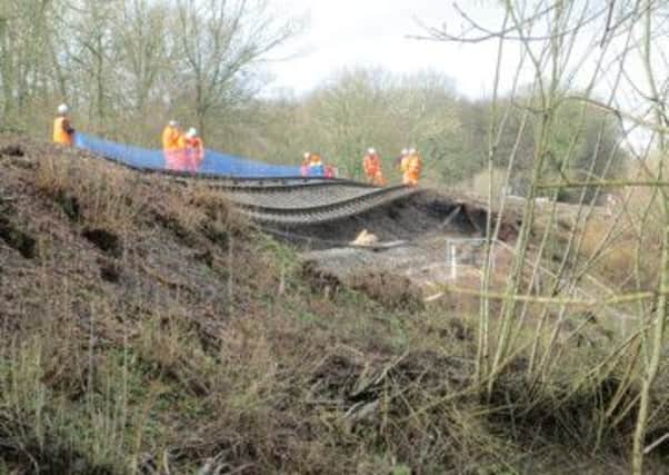 Engineers at work by the landslip in Stonegate which criippled train services ENGSUS00120140213081640
