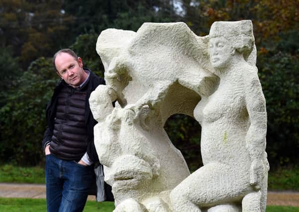 Jon Edgar with his sculpture. Jon Edgar (Sculptor) has created a Roman sculpture at  the RSPB Pulborough Brooks. Picture : Liz Pearce 111114JE06 SUS-141111-162942008