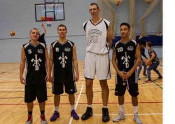 Bob Wegner, the world's tallest basketball player, towers over three of the largest players from the Sussex Elite team. Picture courtesy Web Photo UK Photography